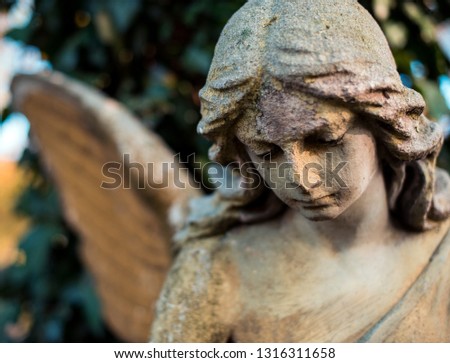 Picture of a sad angel close-up. Symbol of goodness, memory, help and love.