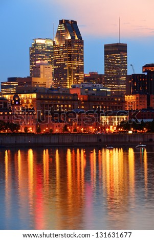 Montreal over river at sunset with city lights and urban buildings