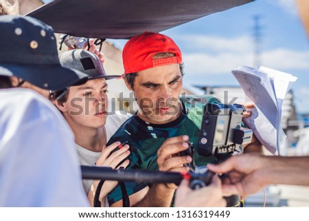 camera operator, director and dp discuss the process of a commercial video shoot