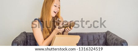 young woman received online shopping parcel opening boxes and buying fashion items by using credit card BANNER, LONG FORMAT