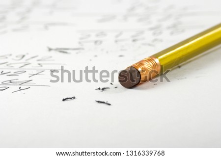 image of a pencil with rubber on a paper with inscriptions