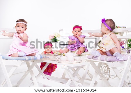 Adorable babies group having tea party