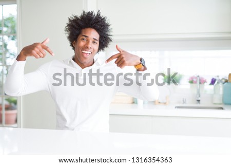 African American man looking confident with smile on face, pointing oneself with fingers proud and happy.