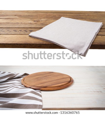 Pizza cutting board. Empty tablecloth set and wood table isolated on white background. Selective focus. Place for food. Top view. Mockup and template copy space.