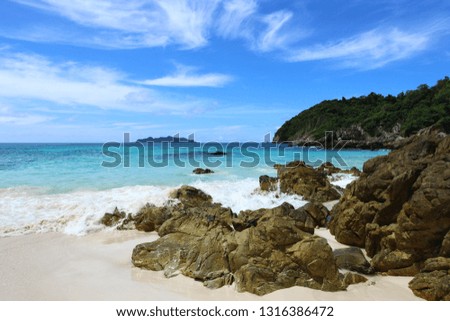 The blue sea and sky with mountain and rock