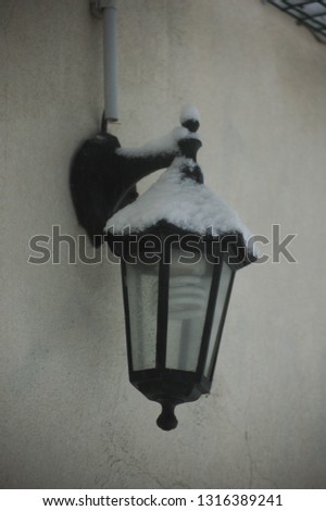 snow-covered street lamp