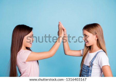 Profile side view portrait of nice-looking cute lovely sweet friendly attractive cheerful straight-haired girls standing clapping palms good decision choice siblings isolated over blue background