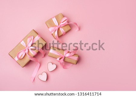 Valentine day composition: white gift boxes with bow and pink hearts. Top View. View from above.