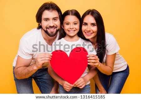 Portrait of nice cute sweet lovely attractive cheerful people holding in hands big large red paper card isolated over shine vivid pastel yellow background