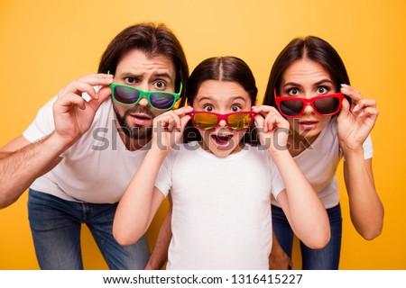 Portrait of nice lovely attractive cheerful amazed people having fun day wearing colorful modern eyewear omg gesture isolated over shine vivid pastel yellow background
