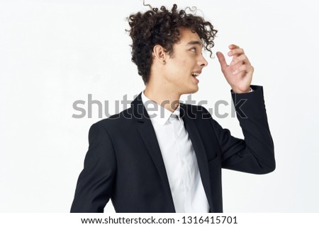 Cute business man in a suit touches his hair
