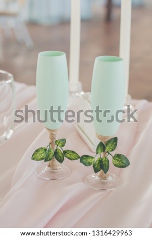wedding glasses mint. wedding mint glasses with greens on the table with a pink tablecloth