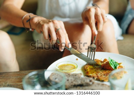 woman eating vegan breakfast organic scrambled eggs with black bread and sauce