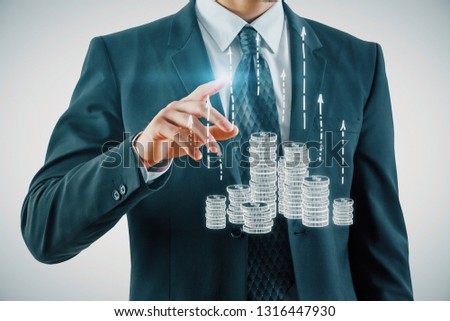 Double exposure with growth coins columns and man hand. Concept of success savings and capital.