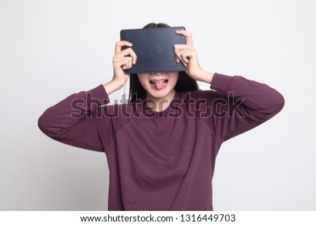 Young Asian woman with a computer tablet over her face on white background