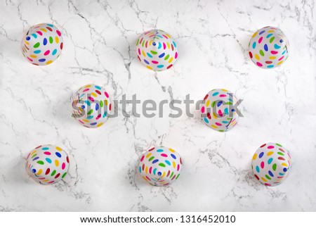 Above view on party hats on marble pattern background. Abstract birthday background. Flat lay