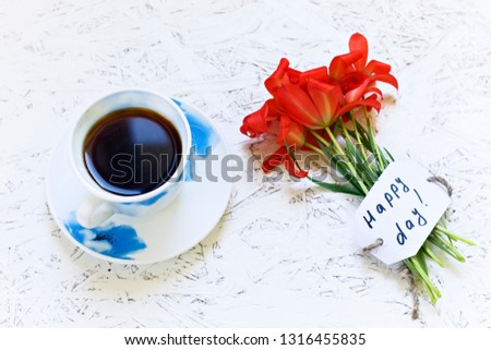 Coffee on white background and flowers. Tulip. Spring. Morning. March 8. Women's Day.