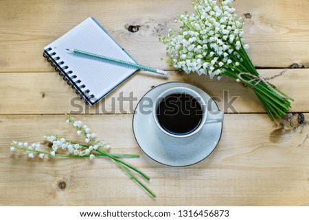 Coffee on a wooden background and flowers. Lilies of the valley. Spring. Morning. March 8. Women's Day