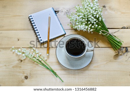 Coffee on a wooden background and flowers. Lilies of the valley. Spring. Morning. March 8. Women's Day