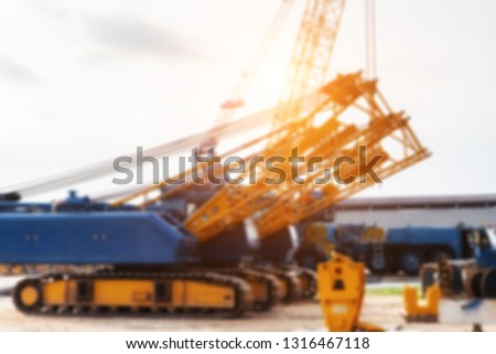 Blur picture of crane factory in Thailand with beautiful sun light.