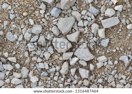 Crushed stones texture on a dirt road. Stones construction rocks. top view. 