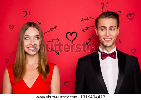 Closr-up portrait of two nice chic lovely attractive imposing cheerful funny flirty people wearing dress and bow tux looking at each other thinking isolated over bright vivid shine red background
