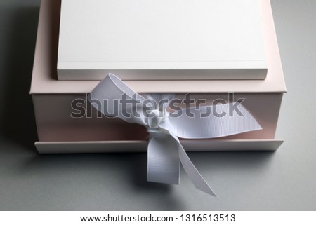 Present with book for smart person. Festive box and book with space for message
