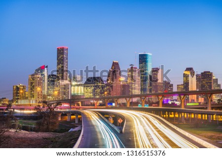 Houston, Texas, USA downtown city skyline and highway at dusk.