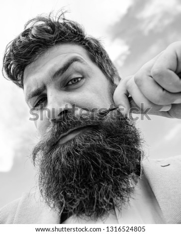 Hipster handsome attractive guy close up. Man bearded hipster twisting mustache sky background. Ultimate moustache grooming guide. Expert tips for growing and maintaining moustache.