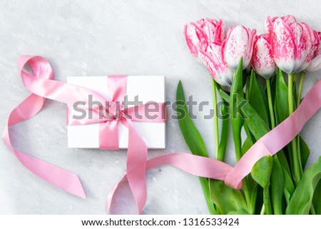 Gift Box and Spring Tulips on marble Background with copy space