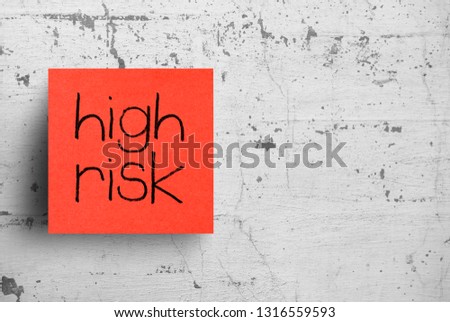 Sticky note on concrete wall, High Risk