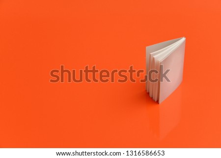 Small white planner on orange background