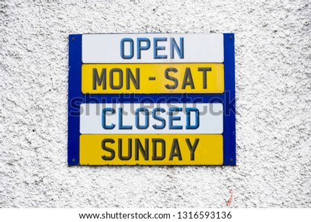 Opening hours shop sign Monday to Friday daytime closed Sunday