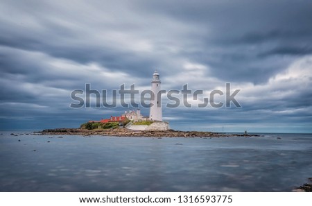 Dramatic sky above St. Mary's Lighthouse. Summer seascape. Whitley Bay, England. Great Britain. Long exposure photography. Main focus on Lighthouse