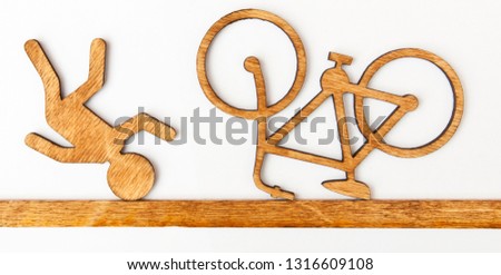 Wooden toy little man and bicycle on white background. Concept accident with cyclist