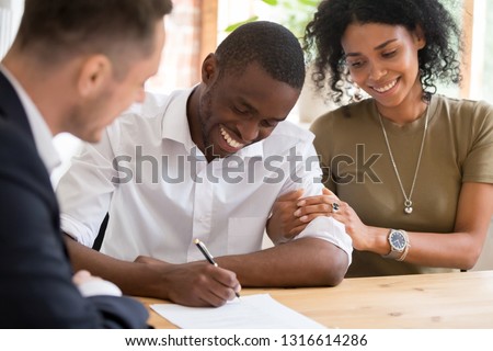 Happy african black family couple customers renters tenants sign mortgage loan investment agreement or rental insurance contract meeting realtor lender landlord making real estate sale purchase deal