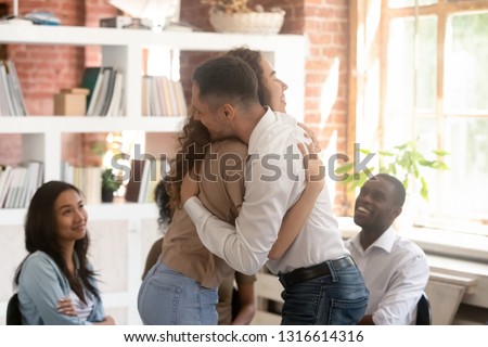 Relieved man and woman hugging giving psychological support empathy during group therapy session, friends people embracing comforting helping overcome problems addiction at psychotherapy counseling Royalty-Free Stock Photo #1316614316
