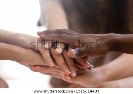 Diverse people group stacked joined hands in pile close up view, multiethnic team friends students together as racial unity concept, partnership coaching training, teambuilding, support in teamwork Royalty-Free Stock Photo #1316614403