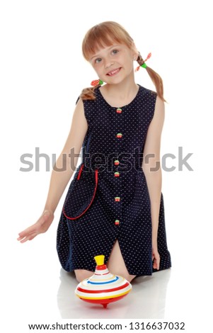 Little girl playing with a whirligig. Isolated on white background.