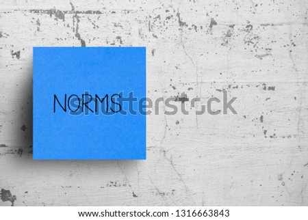 Sticky note on concrete wall, Norms Royalty-Free Stock Photo #1316663843