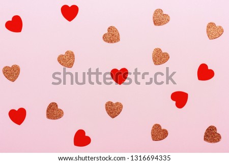 Minimal Valentine's day background. Heart shaped confetti on pink pastel background. Holiday decoration concept.