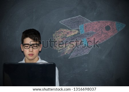 child with laptop and spacecraft or rocket