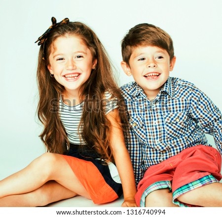 little cute boy and girl hugging playing on white background, happy smiling family, lifestyle people concept close up