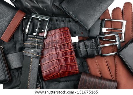 Men's wallet lying on the belts and gloves isolated on white Royalty-Free Stock Photo #131675165