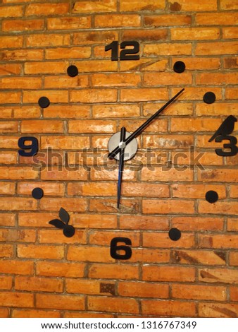 artistic clock on brickwall