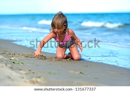  Girl draws on sand