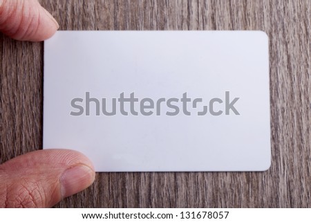 Male hand near a white business card