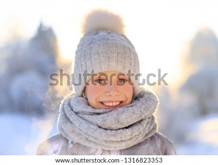 Child playing with snow in winter. Children catch snow flakes