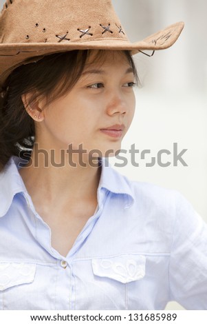 head shot side of asian women with cowboy leather hat