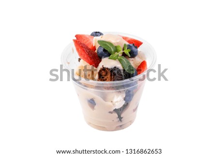 Sweet dessert with biscuit, berry fruit and whipped cream isolated on white background. Delicate delicious dessert decorated with strawberries and blueberries.